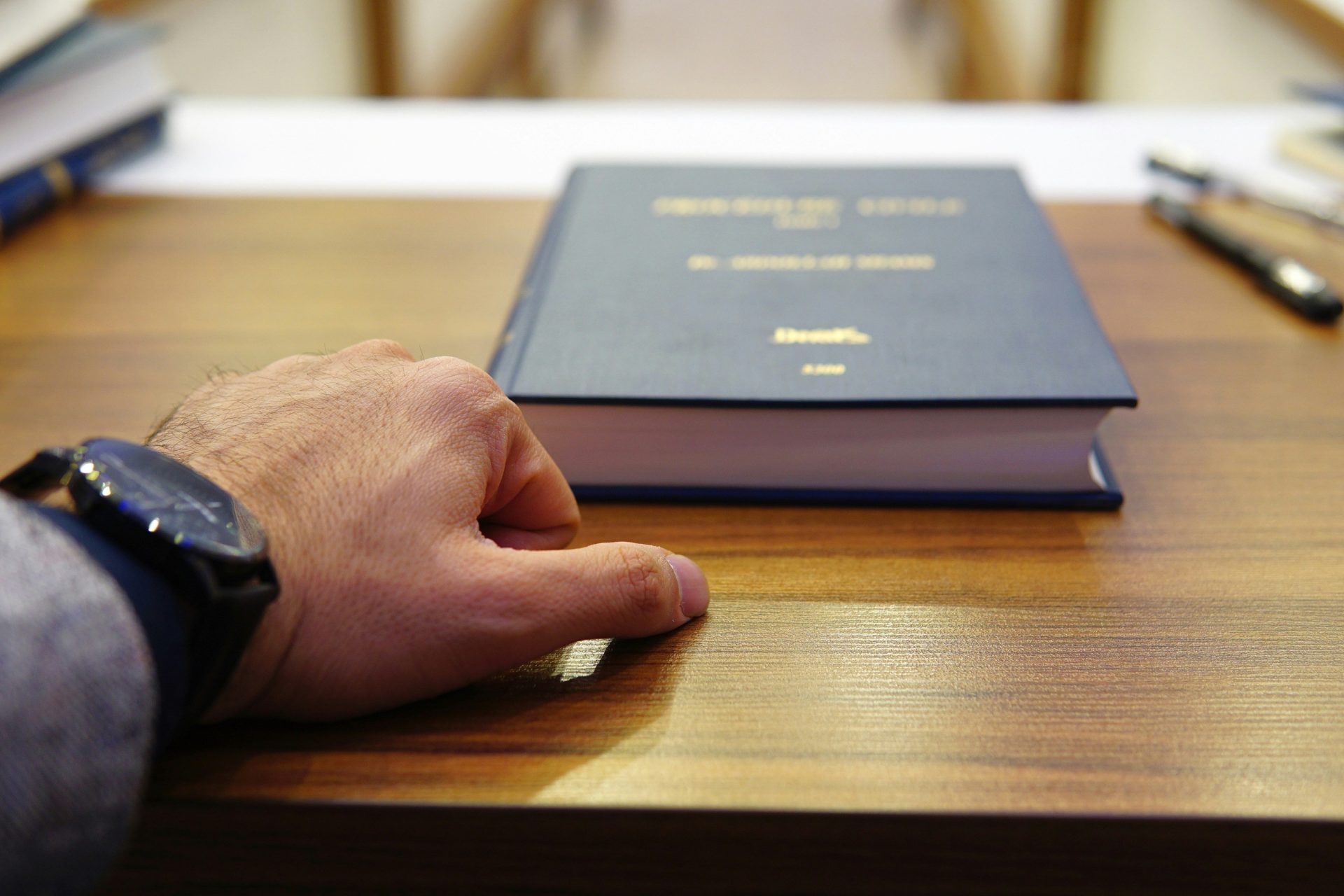Hand resting on book